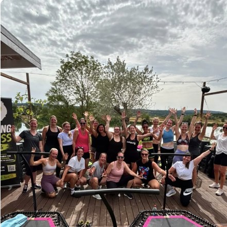Group photo after an outdoor jumping fitness class on the lakeside terrace